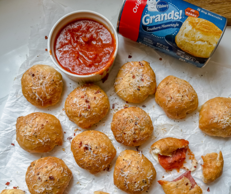 overhead shot of pizza bombs next to a bowl of marinara and a can of Pillsbury Grands