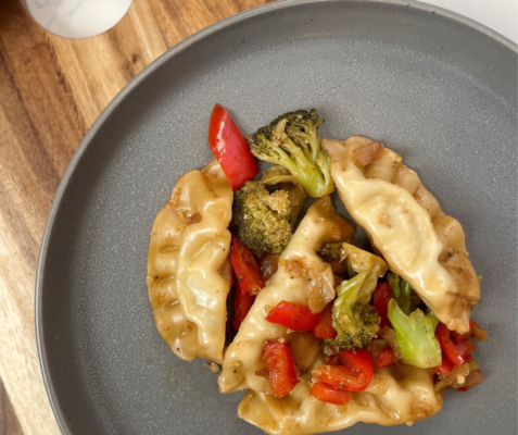 Overhead shot of pot stickers and stir fry vegetables on a plate