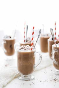 Add the coffee, ice, oat milk and chocolate sauce to a blender and blend on high speed until smooth. Distribute the Frozen Mochas between 6 glasses and top off with CocoWhip, chocolate sauce for garnish and shaved chocolate.