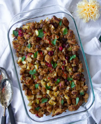 1 tablespoon of butter 8 Jimmy Dean Heat ‘n Serve Original Sausages Patties 1 celery stalk, thinly sliced 1 green apple, chopped 1 (18 oz) bag frozen Jimmy Dean Sausage Skillets 1 cup golden raisins 1 cup cranberries 8 cups artisan focaccia bread cubes for stuffing (you can find this at your supermarket) 3 cups beef broth Fresh parsley Salt and pepper to taste