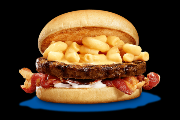 Direct shot of a burger with mac and cheese on it against a black background