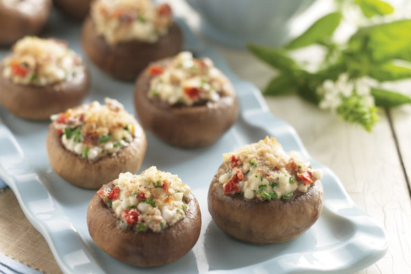 multiple stuffed mushrooms on a plate