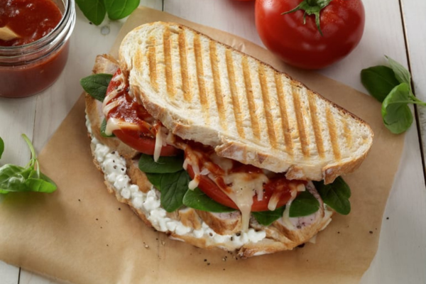 overhead shot of a grilled sandwich filled with veggies and cheese