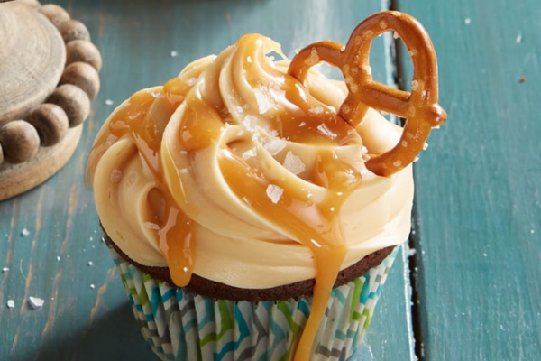 Chocolate cupcake with frosting and a small pretzel on top