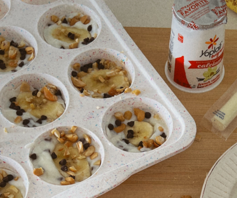 Muffin pan filled with yogurt with toppings