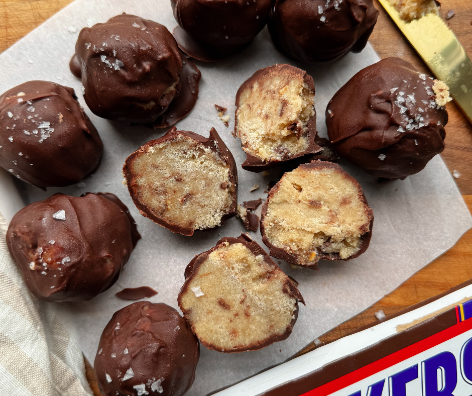 a bunch of Cookie dough ice cream balls with two cut open in the middle