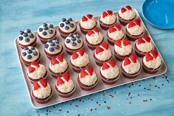 Cupcake Flag Cake on a tray sitting on a blue table with red white and blue star confetti