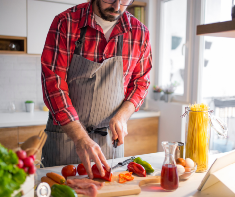 a man chopping vegetables in a kitchen