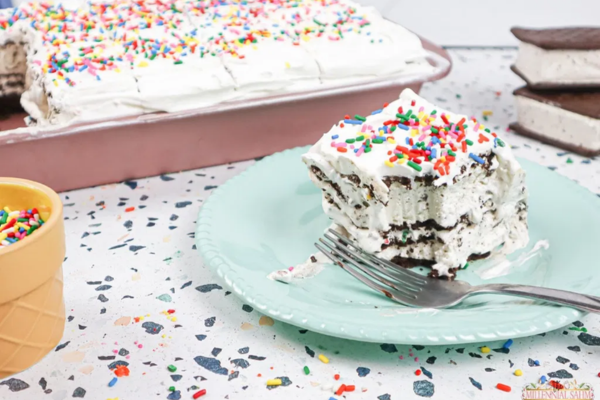 ice cream cake on a blue plate with a tray of ice cream cake in the background