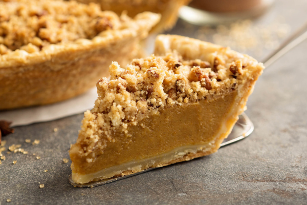 a slice of pumpkin pie with streusel on top