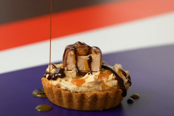 mini pie being drizzled with chocolate sauce