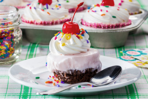 Close up shot of an ice cream sundae cupcake on a plate