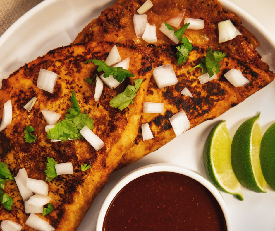 close up of two tacos on a plate