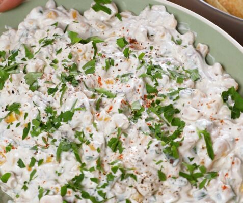 Close up image of a bowl of jalapeno and bacon corn dip