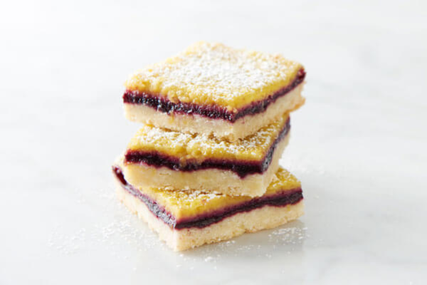 three lemon berry bars stacked on top of each other