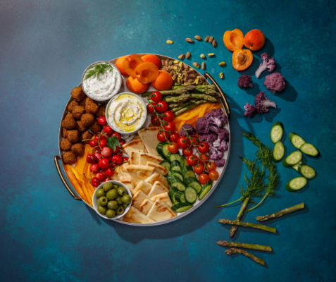 Overhead shot of large bowl filled with Mediterranean snack platter