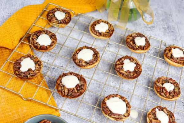 mini pecan pies on a cooling tray