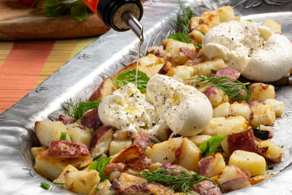baking dish with roasted potatoes and burrata cheese 