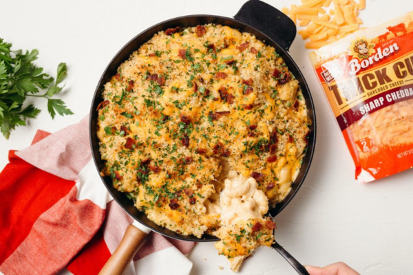 Overhead shot of pan filled with baked mac and cheese with a spoon scooping some out