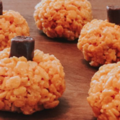 Mini pumpkins made with orange rice crispies and a tootsie roll stem