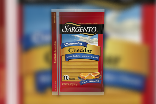 Close up shot of sargento cheddar creamery slices against a blurred background of the packaging