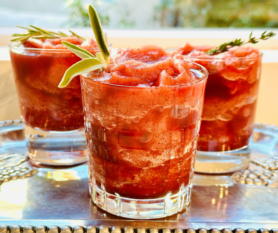 Three glass cups filled with cherry slushy old fashioned