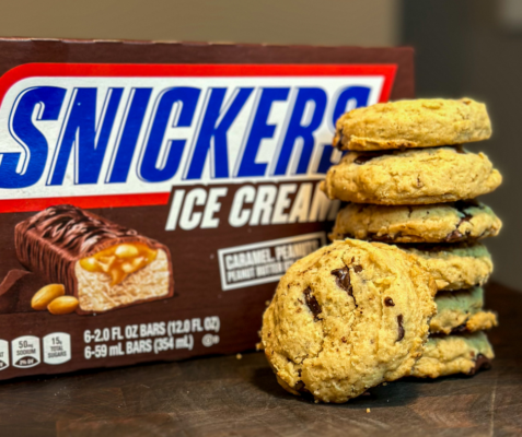 Stacked Snickers Ice Cream Cookies in front of a box of Snickers Ice Cream Bars