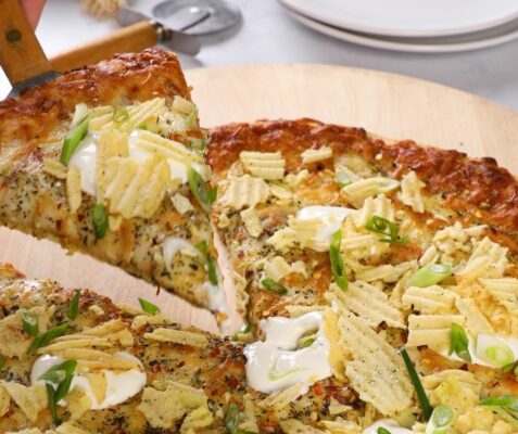 a slice of Sour Cream and Onion Potato Chip Pizza being cut out