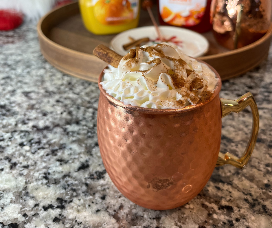 Spiked apple cider inside of a copper mug