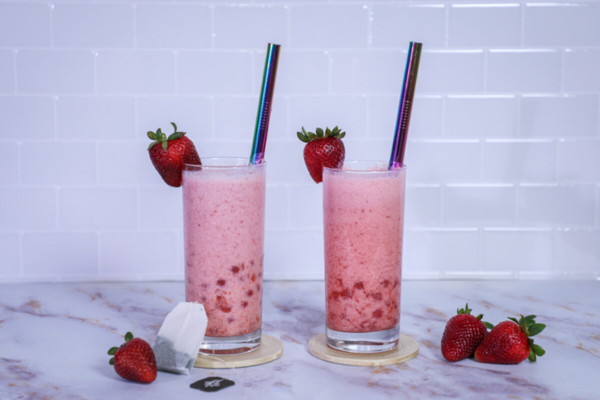 Head on shot of two clear glasses with strawberry lemonade boba inside 