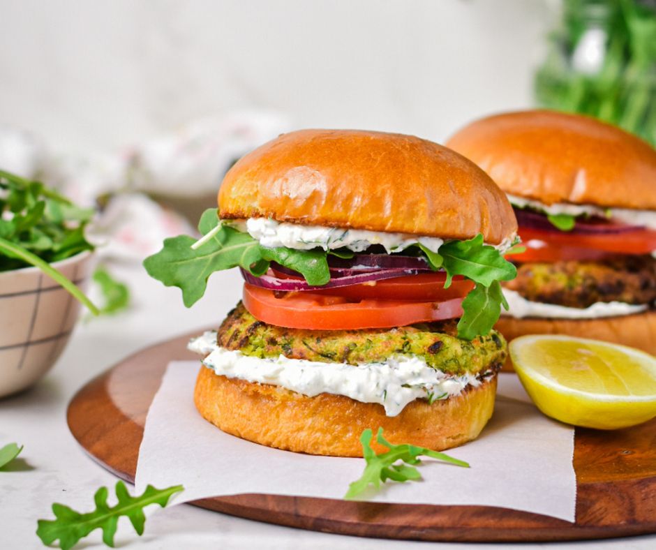 Two burgers on a cutting board