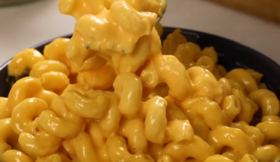 a fork scooping mac and cheese out of a bowl