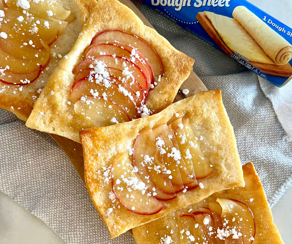 four apple tarts next to each other