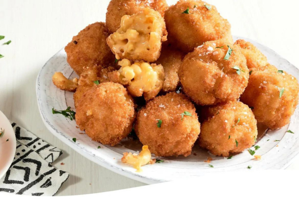 Mac and cheese balls stacked on a plate