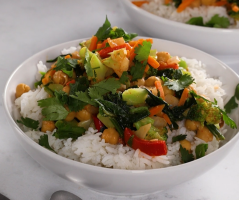 A white bowl filled with rice and vegetable curry