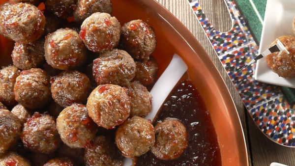 a close up shot of a red bowl filled with chipotle meatballs