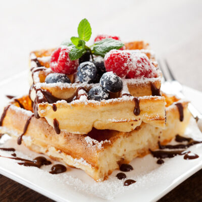 Waffles with chocolate drizzle and berries