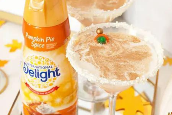 Pumpkin Spice Martini next to a bottle of international delight pumpkin spice creamer